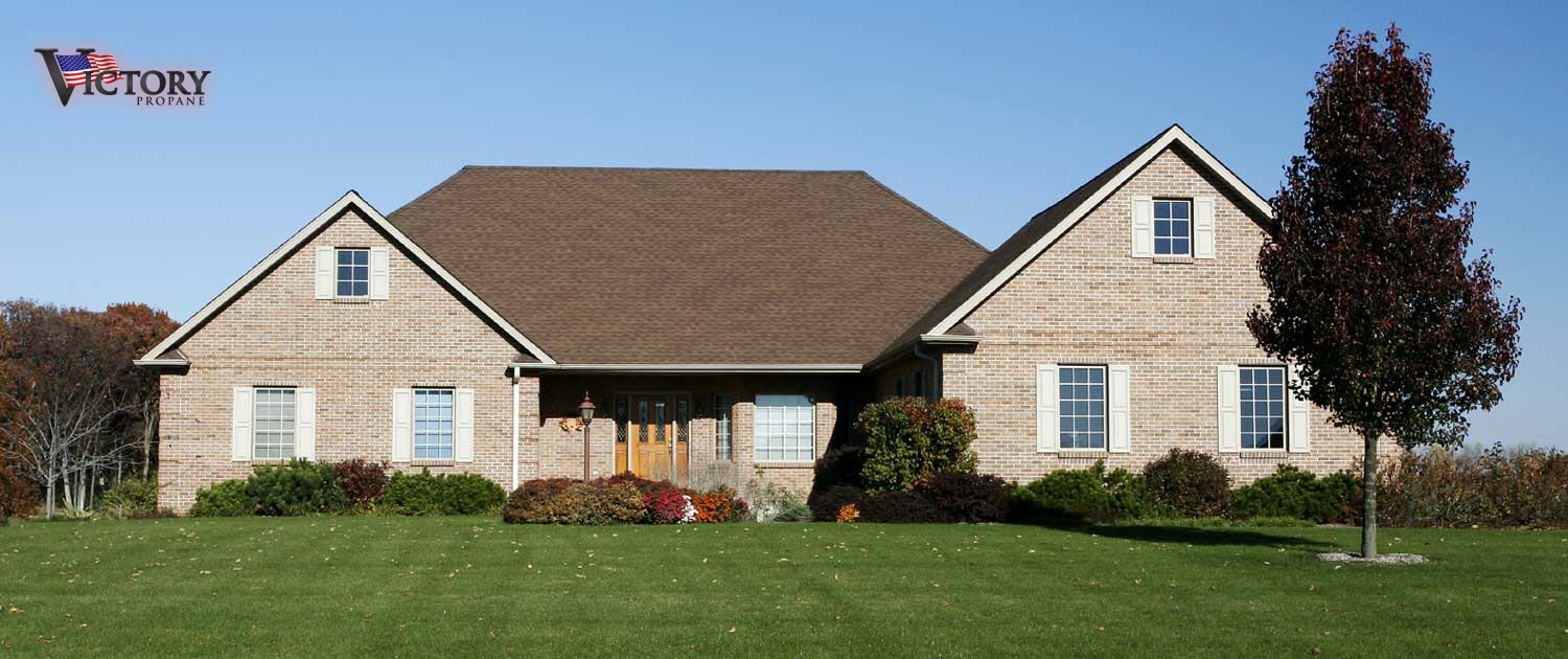residential two-story home looking at the front with a tree in the yard